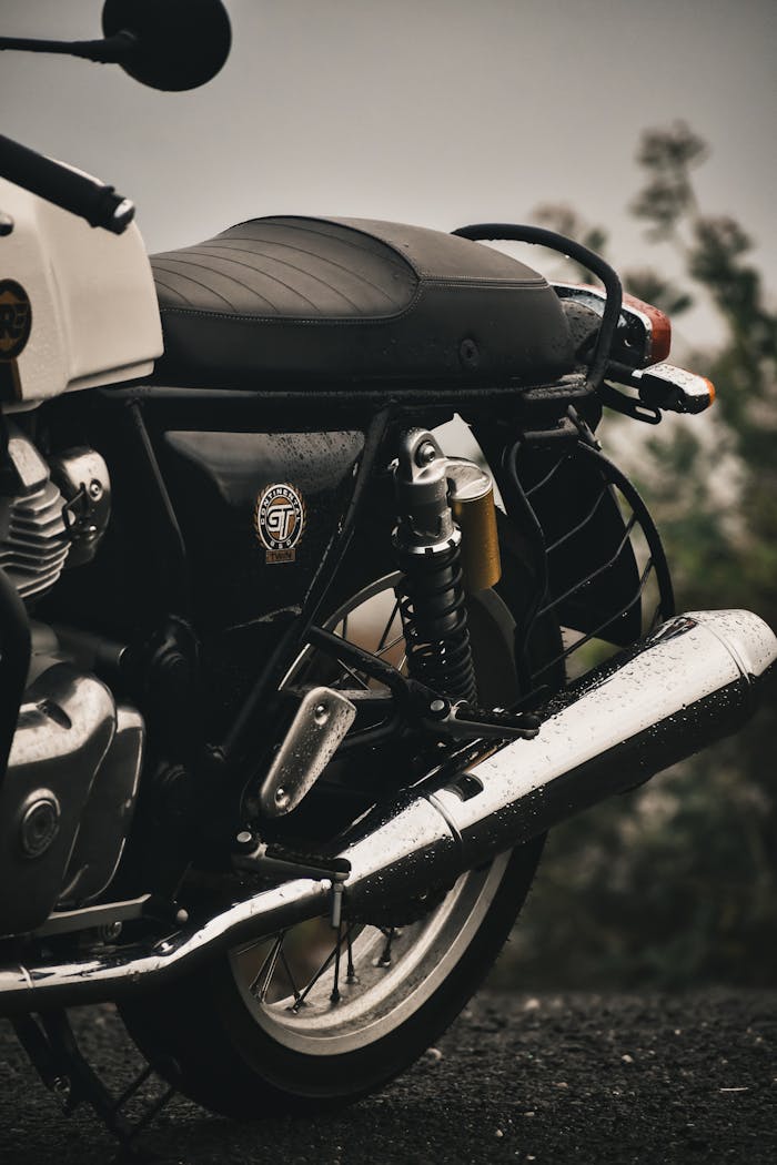Close-up of a Royal Enfield motorcycle on a rainy day in Kanyakumari, India.