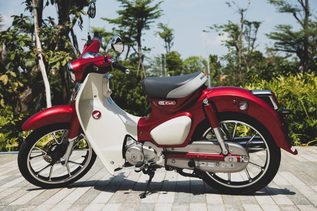 Crafting Captivating Headlines: Your awesome post title goes here A vintage-style red Honda Super Cub motorcycle parked outdoors in Vietnam.