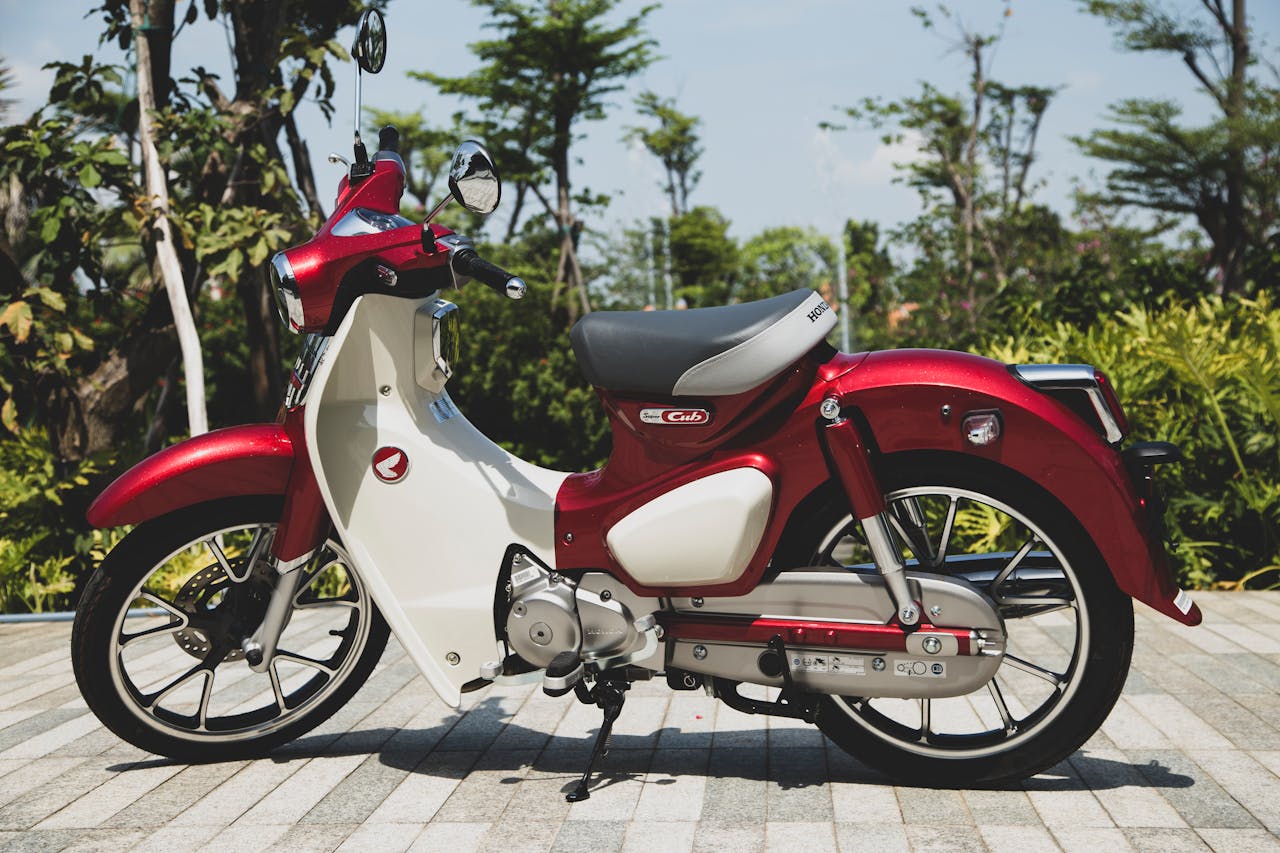 A vintage-style red Honda Super Cub motorcycle parked outdoors in Vietnam.