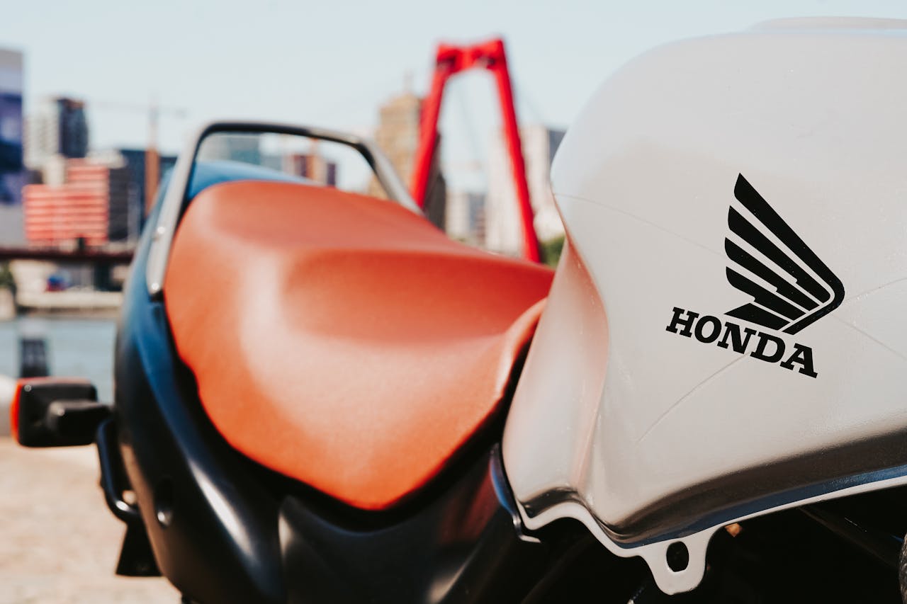 A stylish close-up of a Honda motorcycle with cityscape in the background.